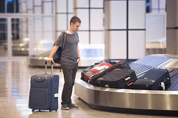 istock Young man waiting for luggage 507570132