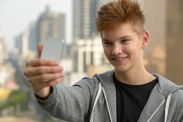 istock Teenager boy outdoors taking selfie 507570218