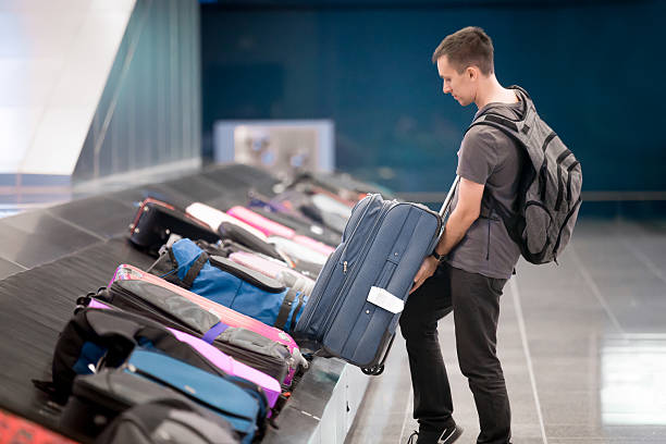 istock Young man collecting his luggage 507570252