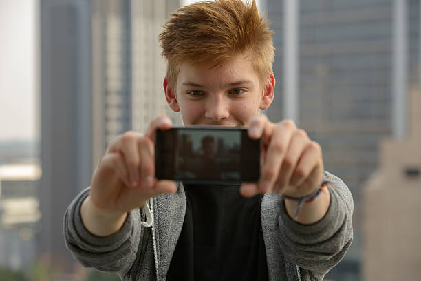 istock Teenager boy outdoors taking selfie 507570580