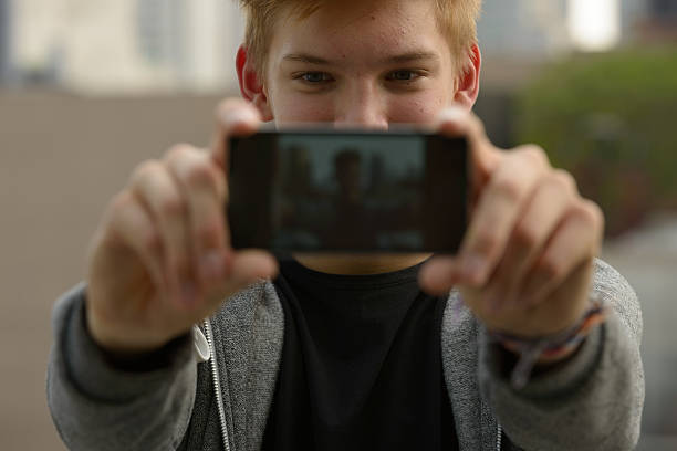 istock Teenager boy outdoors taking selfie 507570866