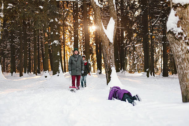 istock Young family having fun in winter forest 507572282