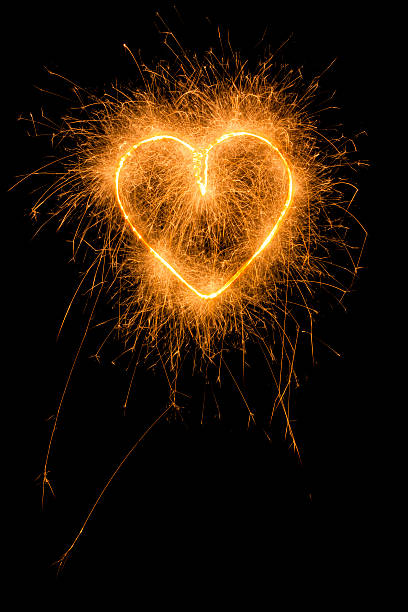 istock burning sparkling heart glowing in the dark 507573208