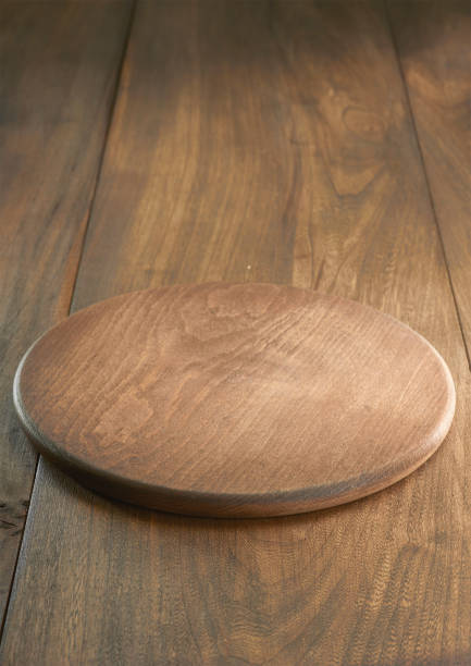 Empty wooden plate on wooden background