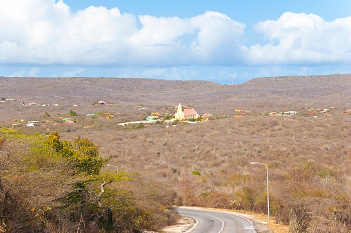 Scenic view of Sint Willibrordus with church in Center. Characteristic for Curacao landscape are cacti, small dividive trees, acacia bushes, scraggly trees with small green leaves and long, hard thorns, covering the most Areas.