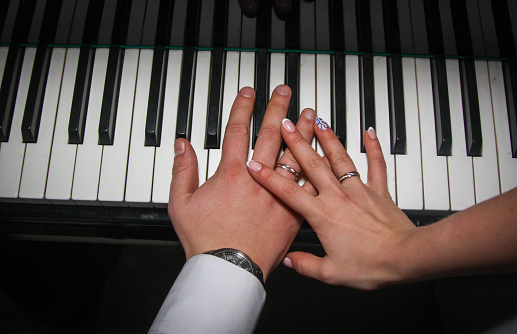 hand of a woman playing the piano