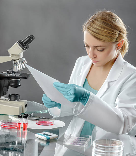 istock Young female scientist works in laboratory 507574254