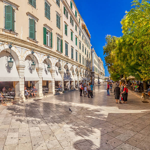 Famous cafes at building at Kapodistriou street Kerkyra, Corfu, Greece - September 24, 2013: Famous cafes at building at Kapodistriou street with lot of tourists. This street located near platia Enoseos at old city. corfu holiday palace stock pictures, royalty-free photos & images