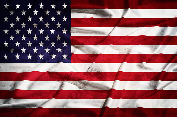 istock United States grunge  flag on a silk drape 507577089