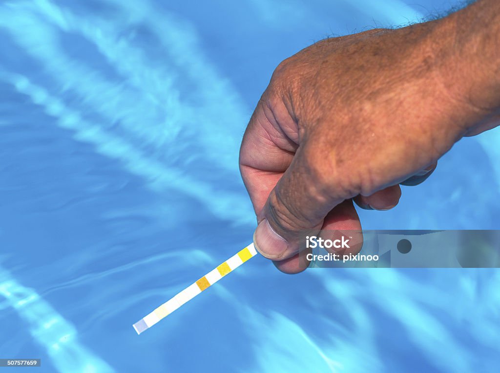 Check the pH of a private swimming pool Check the Ph of a private swimming pool Acid Stock Photo