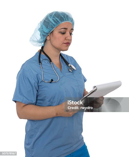 Pacific Islander Doctor In Scrubs Stock Photo - Download Image Now - Adult, Analyzing, Brown Hair