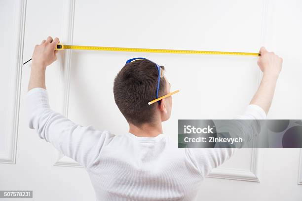 Young Handsome Worker With Measuring Tape Stock Photo - Download Image Now - Adult, Beautiful People, Blue-collar Worker