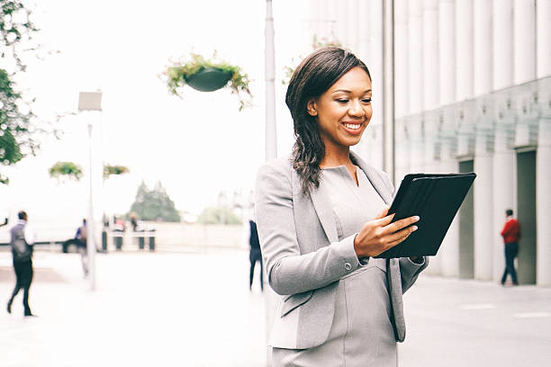 ritratto di donna d'affari di successo utilizzando tablet nel paesaggio urbano - mobility working digital tablet people foto e immagini stock