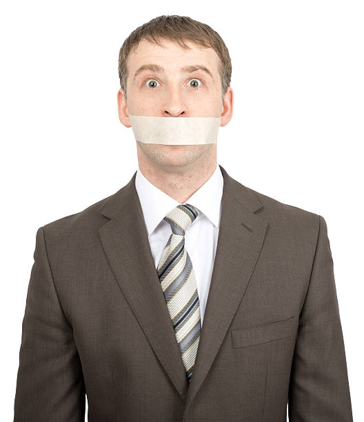 istock Scared businessman with tape over his mouth 507578620