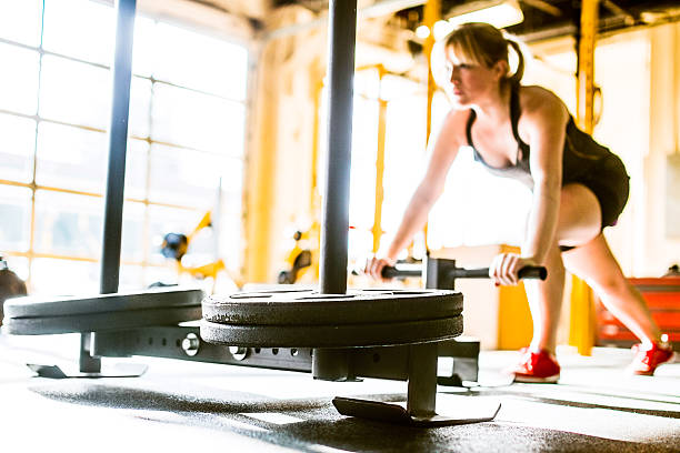 istock Sled Push Woman Working Out 507580257