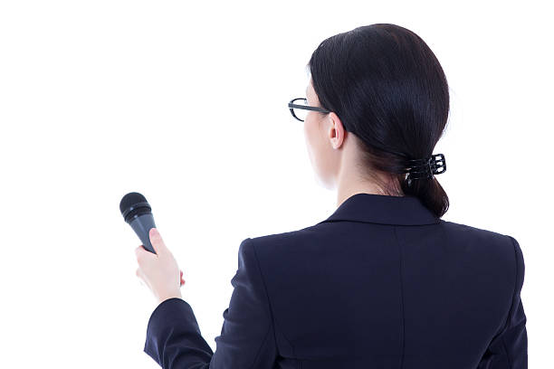 back view of female journalist with microphone isolated on white stock photo