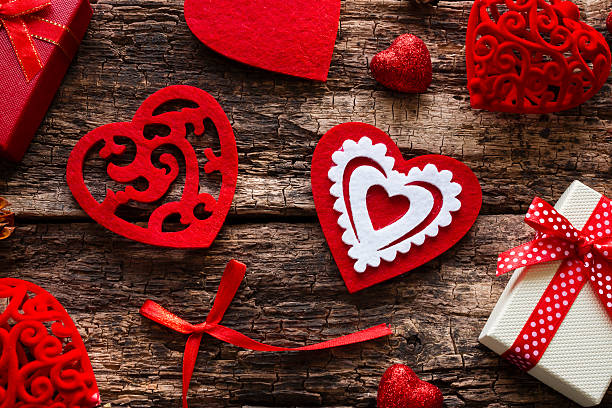 istock gift boxes, red hearts and bow on a wooden background 507580504