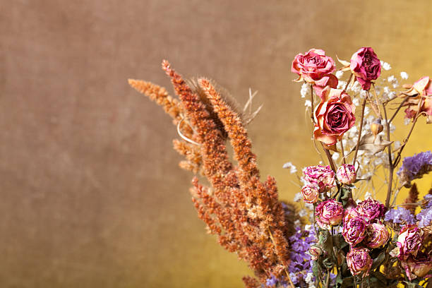 Bouquet of dry flowers on burlap background. Selective focus.