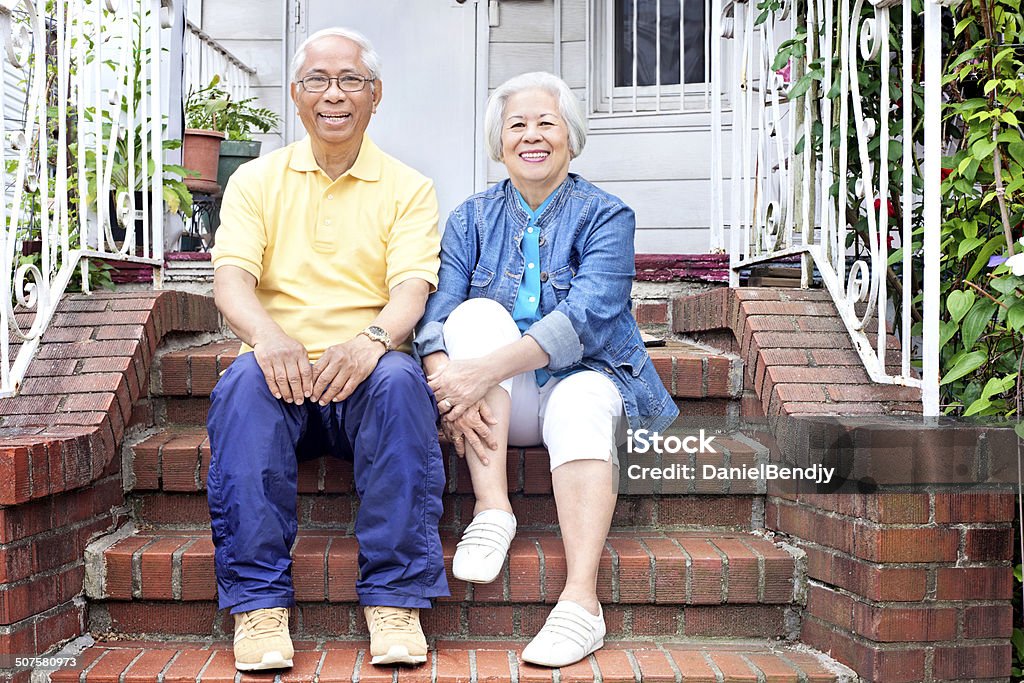 Happy Old Couple Happy old Asian couple in front of their home in Queens, New York city. New York City Stock Photo