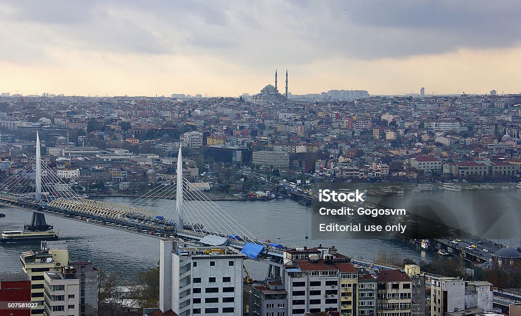 Eminonu, Goldenhorn Istanbul, Turkey - December 14, 2013: There is a panaromic istanbul wiev with Karakoy, galata bridge and suleymaniye mosque. It's a medieval stone tower in the Galata/Karakoy quarter of Istanbul, just to the north of the Golden Horn and one of the city's most striking landmarks. Boats are anchored to Eminonu pier where is near the New(yeni) Mosque waiting for its passengers to get on board. Ancient Stock Photo