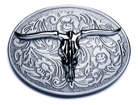 San Diego, California, United States - July 30th 2014: This belt buckle is brand new and was purchased from a souvenir shop in San Diego. The belt buckle is a part of the belt to clasp it and hold up pants, but it also a part of fashion and design. Belt buckles go all the way back to the iron age. The Western style belt buckle became largely popular through Western movies.