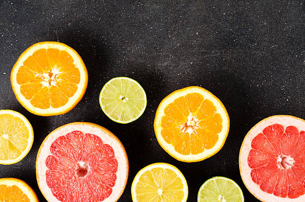 istock Mix of citrus fruits on dark table 507581364