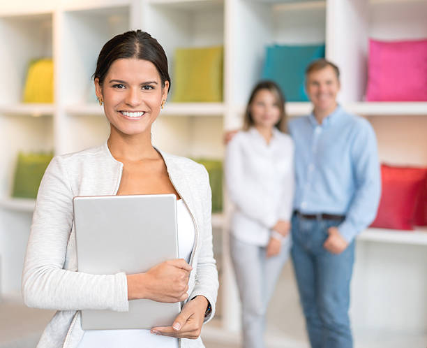 saleswoman helping customers at a furniture store - furniture store furniture retail textile imagens e fotografias de stock