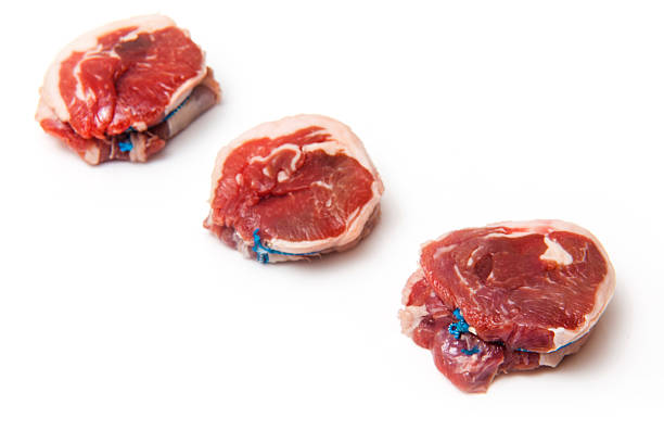 Goat meat noisettes iolsated on a white studio background.