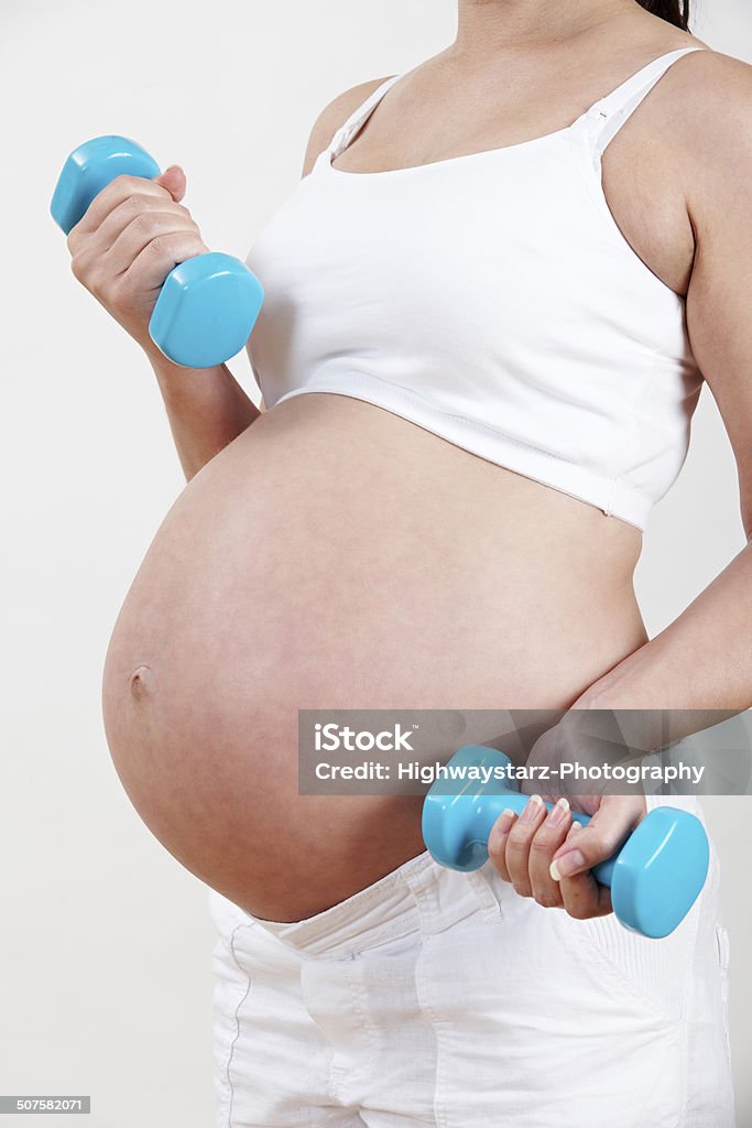 Close Up Of Pregnant Woman Exercising With Weights Pilates Stock Photo