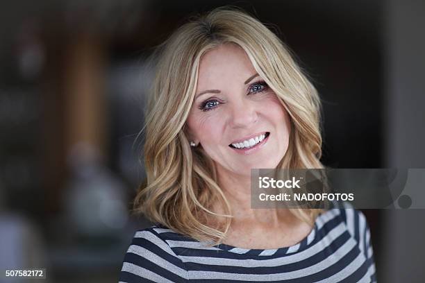 Mature Woman Smiling At The Camera Stock Photo - Download Image Now - Women, One Woman Only, Mature Women