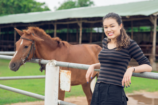 Young girl and a pony in the paddock