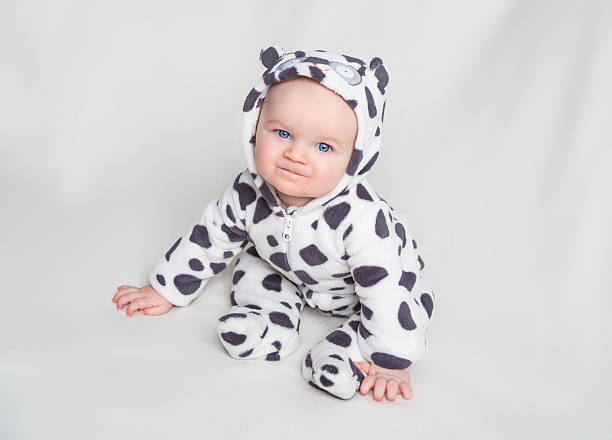 istock Kid in leopard dress sits smiling 507582334