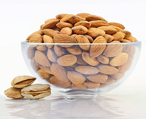 istock nuts almonds in glass bowl 507582428