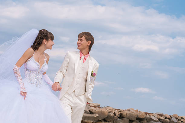 istock Young and beautiful bride and groom on the beach 507583279
