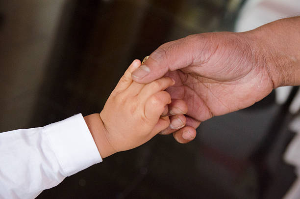 istock Little and big hand touch 507583701