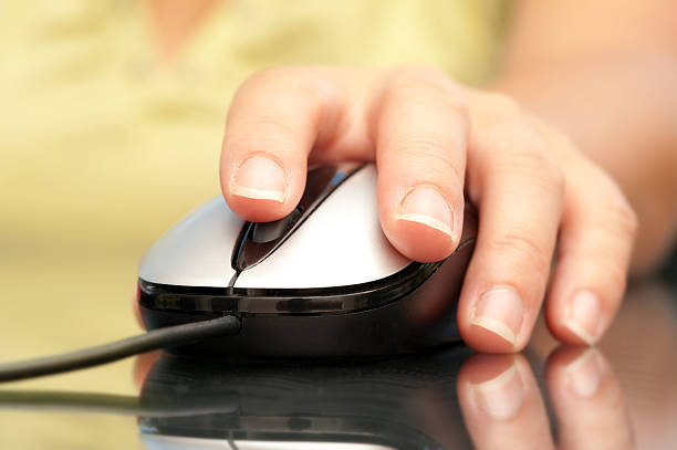 istock Woman hand holding mouse 507616073