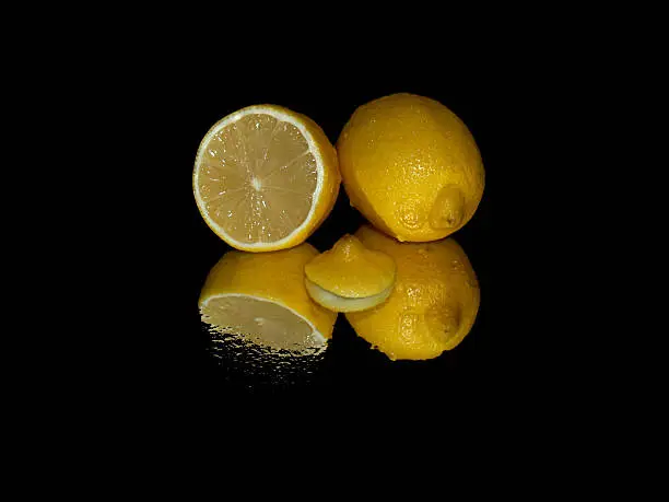 yellow, juicy lemon reflected in a mirror.