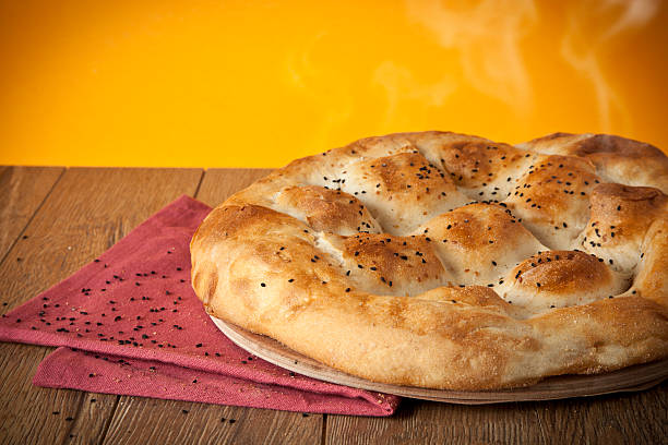 istock Turkish Ramadan Bread, Ramazan Pidesi wooden table with yellow background 507616201