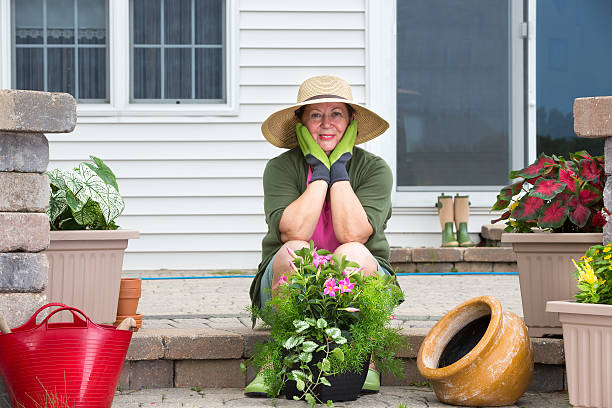 istock Elderly woman pausing while potting up plants 507616861