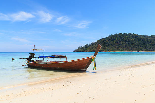 istock Boat on the beach with blue sky 507617475