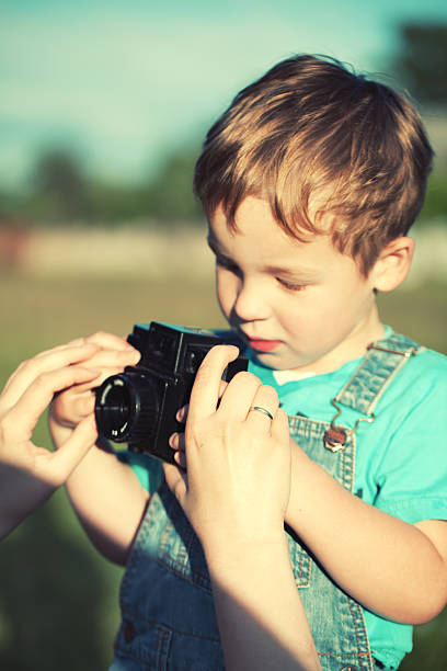 istock Mother helping her son to make his first photos 507618023