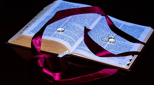 Bible and Wedding Rings Bible describing love in total. verses stock pictures, royalty-free photos & images