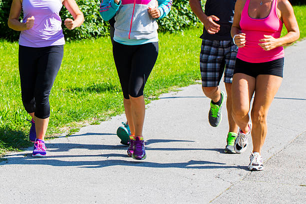 istock Group of runners jogging through park 507620699