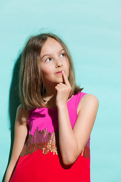 маленький мода модель мышление - child little girls shy standing стоковые фото и изображения
