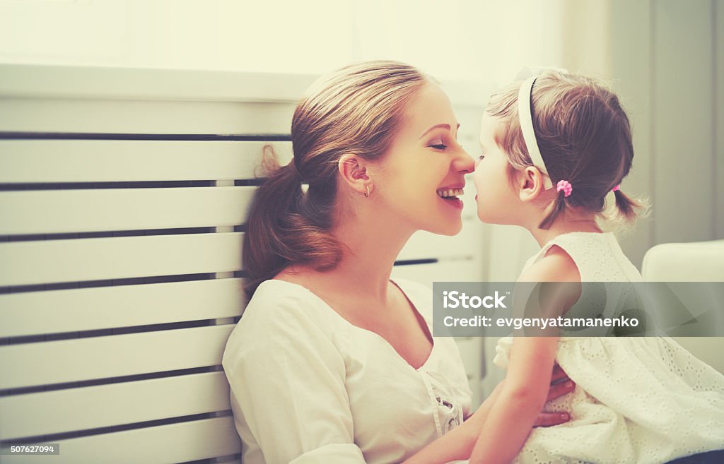 Happy loving family. mother and child playing,  kissing and hugg Happy loving family. mother and child girl playing, kissing and hugging Adult Stock Photo