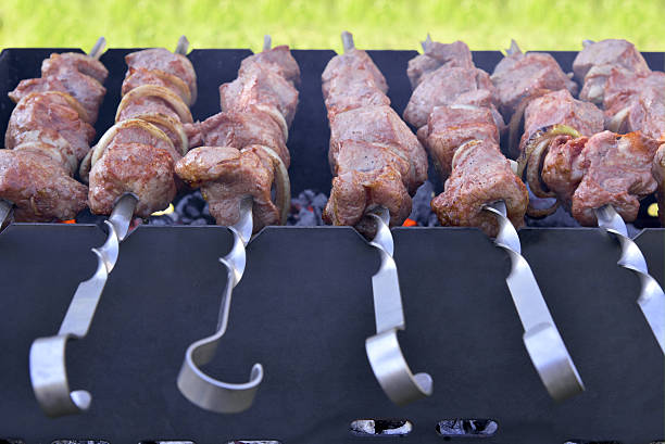 Succulent meat on a skewer on the grill stock photo