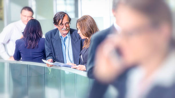 istock Businesspeople during break in modern office corridor 507630084