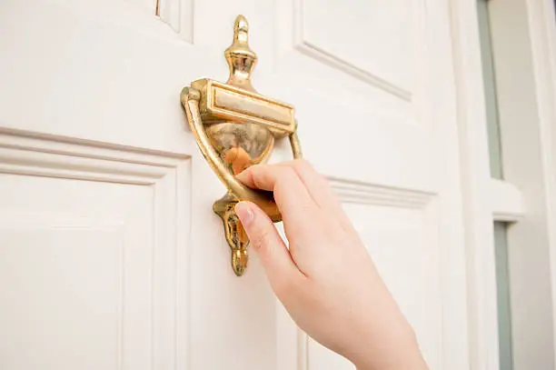 woman holding at the door using the old knock door