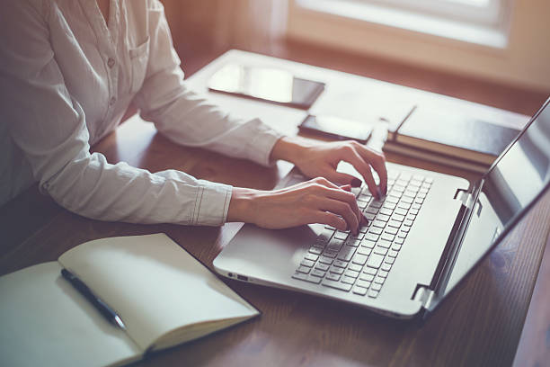 istock Woman working in home office hand on keyboard close up 507631072