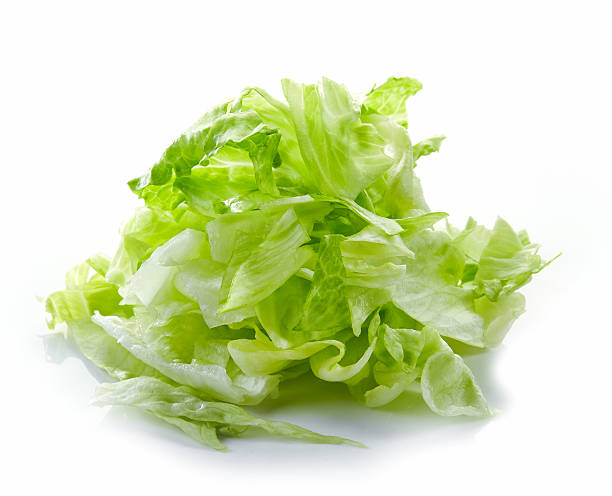 Heap of chopped iceberg lettuce Heap of chopped iceberg lettuce isolated on white background chopping food stock pictures, royalty-free photos & images